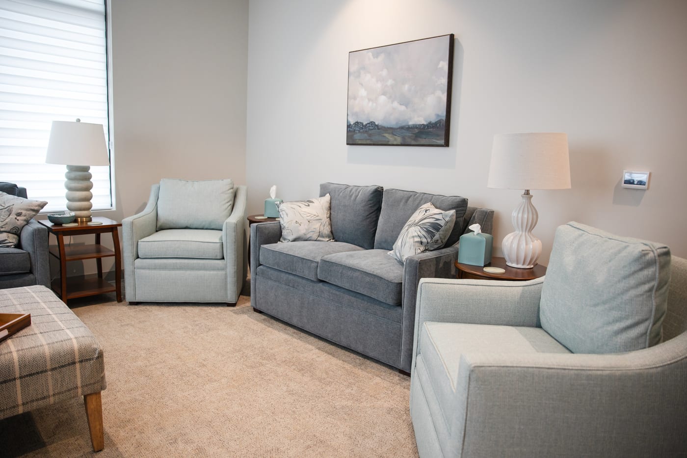 A quiet seating area for one-to-one counseling, two armchairs and a sofa