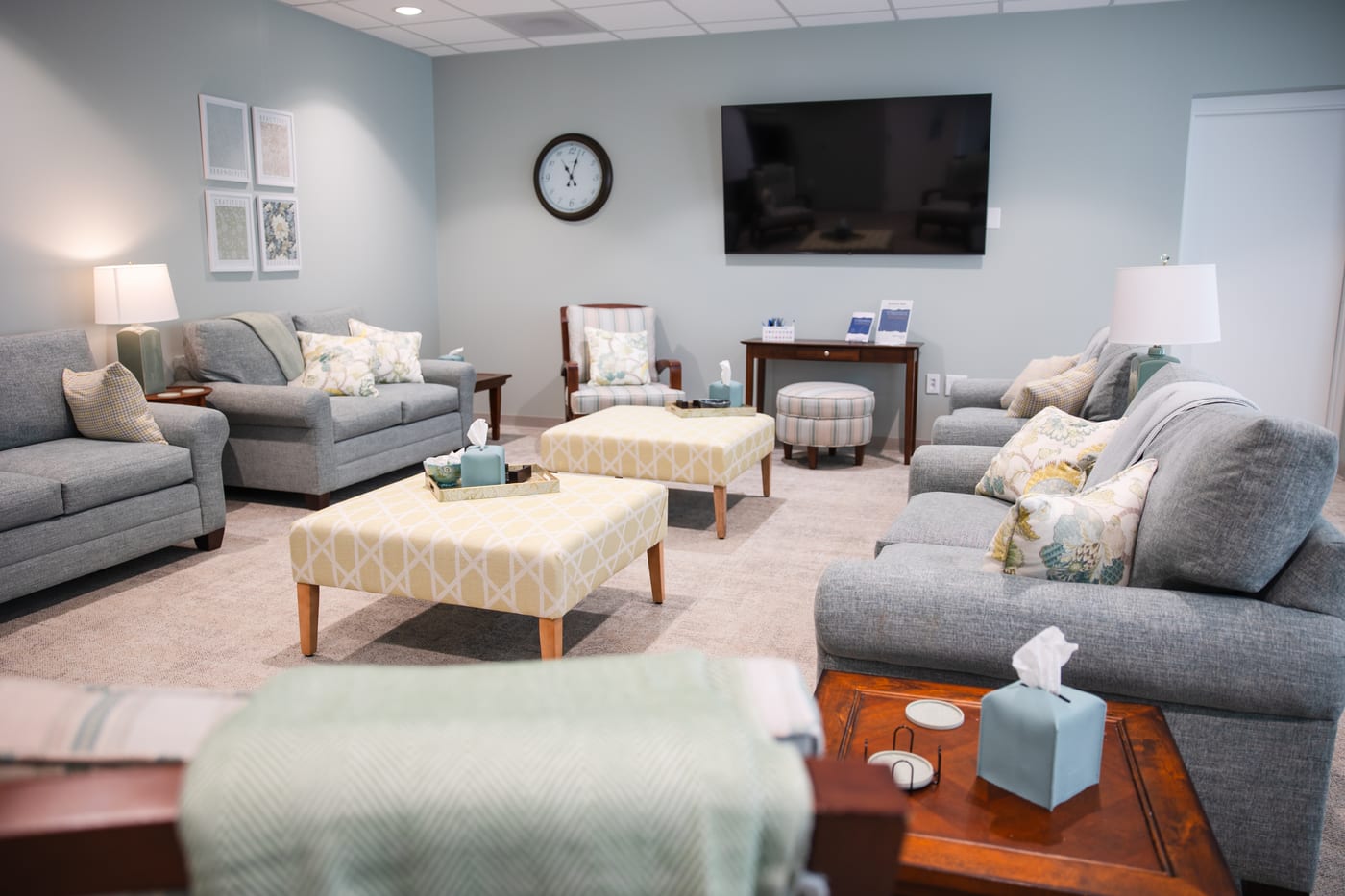 A larger room set up for group sessions, with sofas arranged around ottomans
